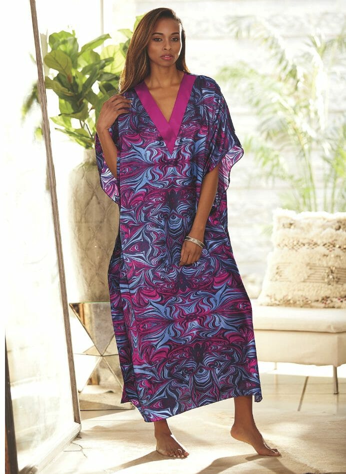 Black woman wearing pink and blue print caftan