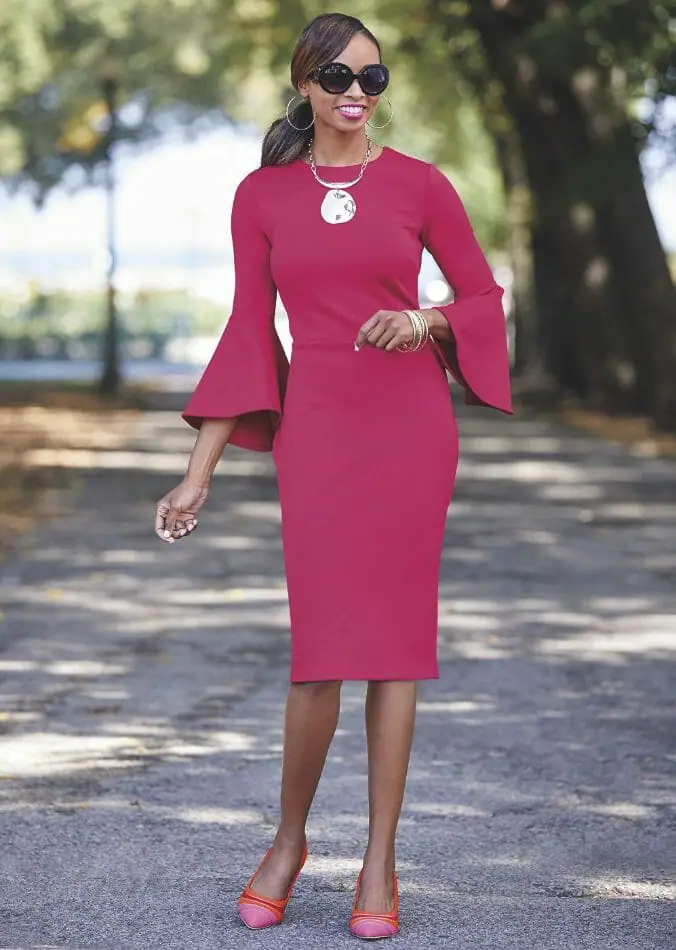 African-American woman in red-pink dress with flowy sleeves