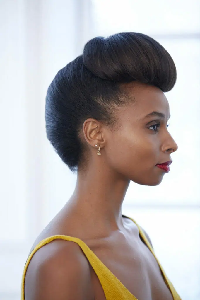 A black woman with a French twist and Pompadour hairstyle.
