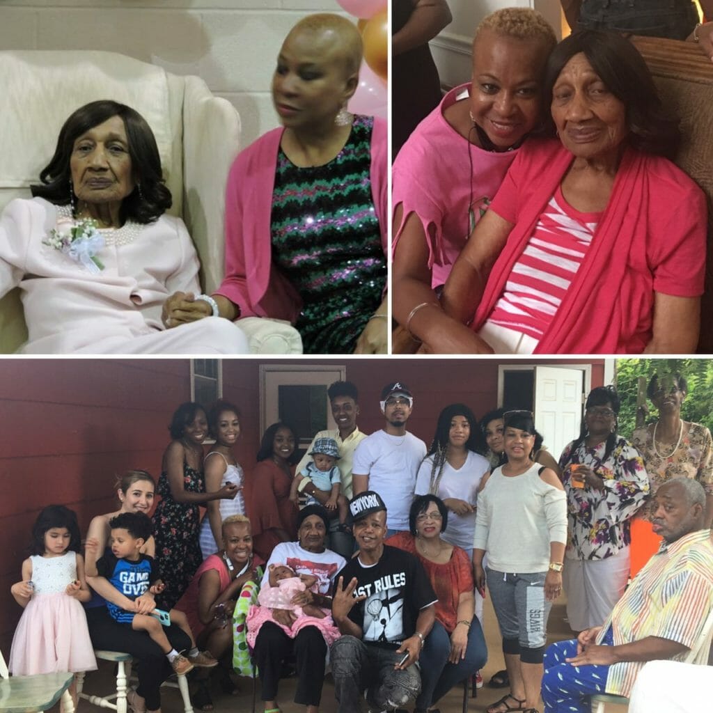 A black Mother and Daughter together, and family in front of a house.