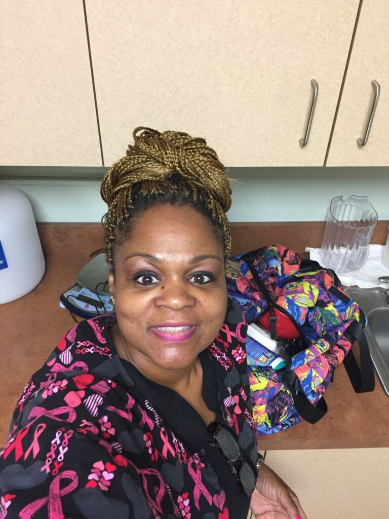 Ashro Woman of the Week, Latasha, an African-American woman wearing a colorful print top and hair in a high bun.