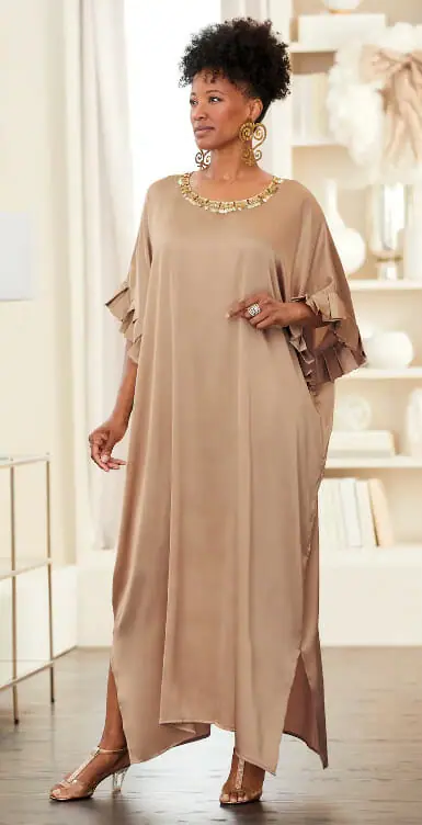 Black woman wearing a neutral caftan