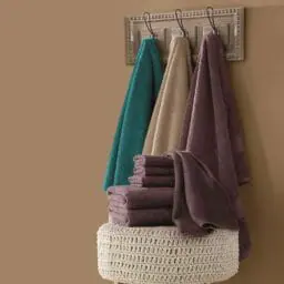 Color Connection 6-Piece Towel Set on hooks with knit ottoman