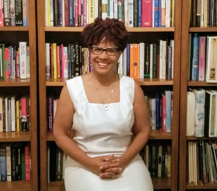 Black woman wearing white dress