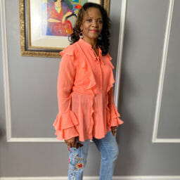 Ashro customer wearing flowy top & jeans