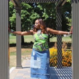 Vertical Image of woman posing in jean skirt and green top