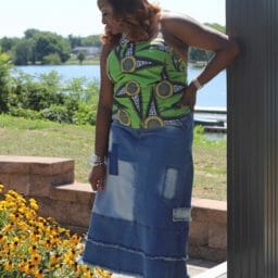 Vertical Image of woman posing in jean skirt and green top