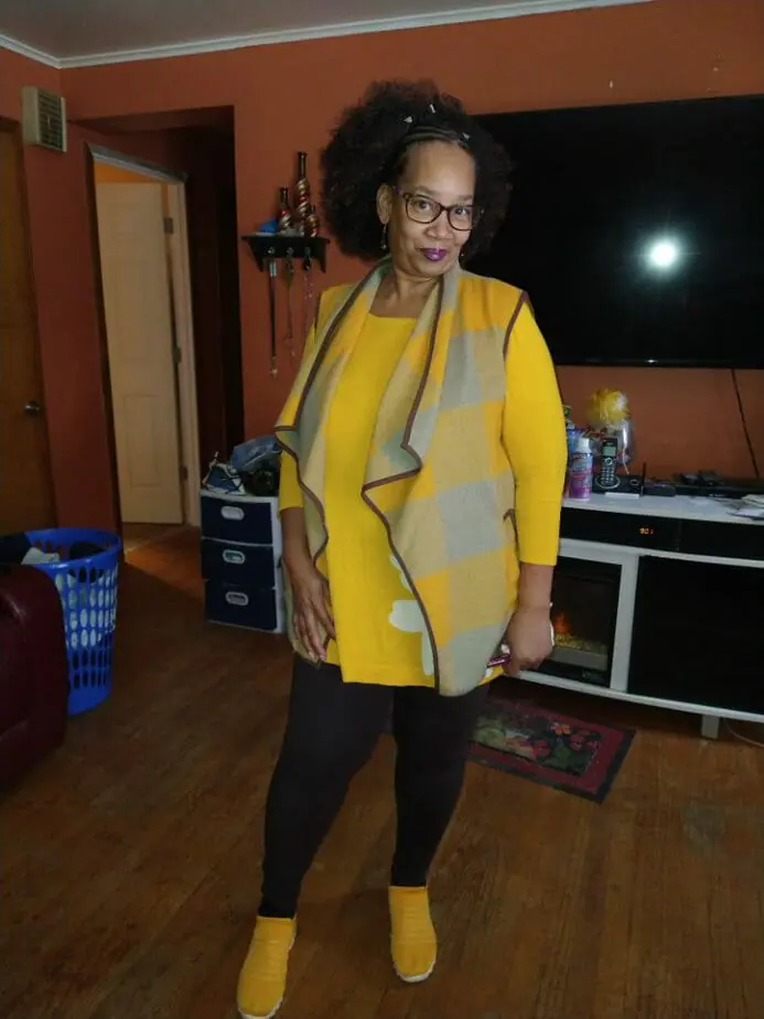 Ashro customer posing wearing yellow shirt and blazer