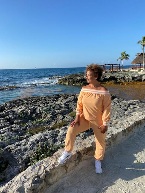 Black woman at the beach wearing Ashro