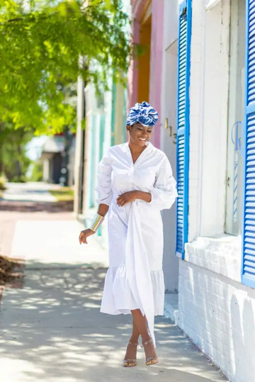 How Do You Wear White? Three smiling black women wearing either a jacket dress, a dressy sleeveless dress, or a pantsuit.