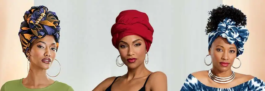 Three African American women wearing different styles, colors and prints of headwraps, in orange, purple and black, red, and white and blue.
