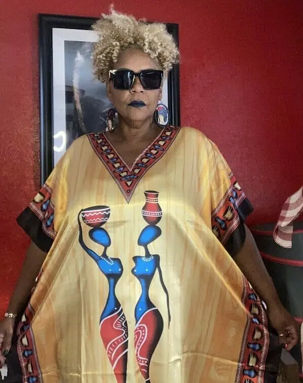 Image of a woman wearing a caftan with African imagery.