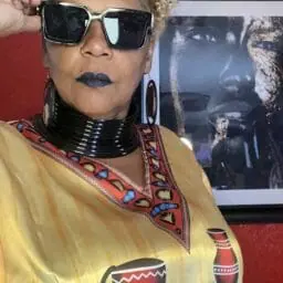 Image of a woman wearing a caftan with African imagery.