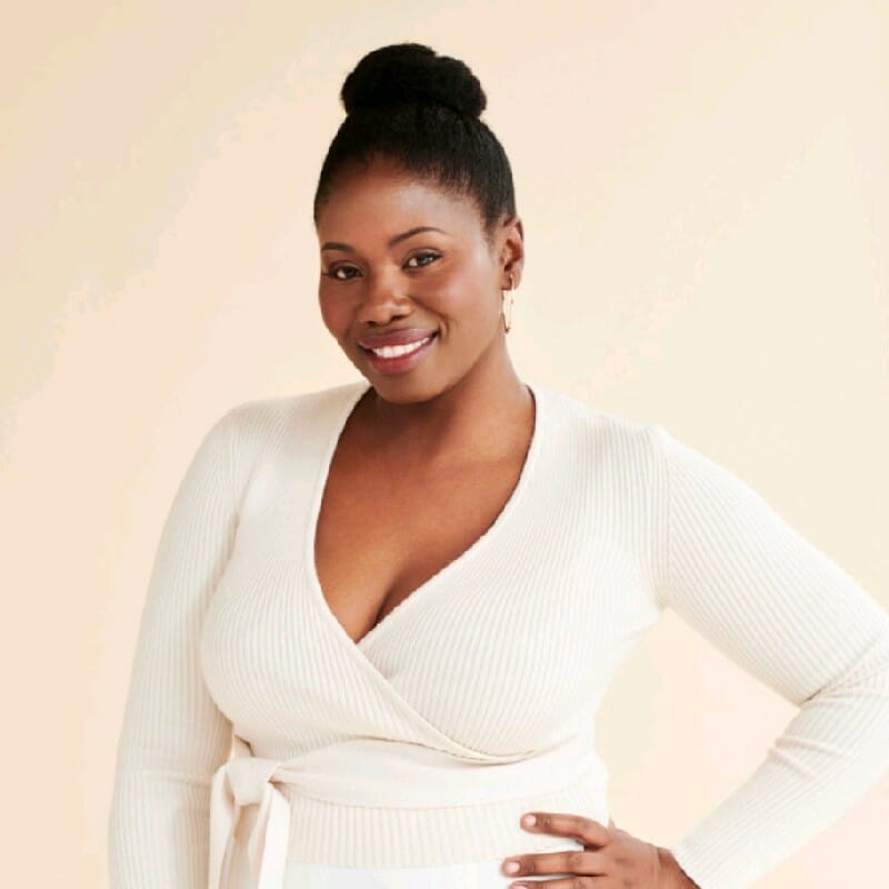 Black woman posing and smiling for headshot.