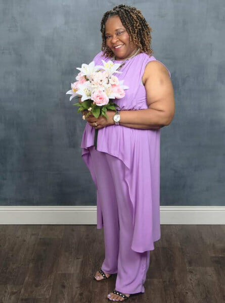 woman in purple holding flowers