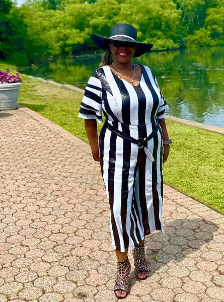 woman in a black and white outfit standing on a patio