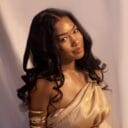 Black Woman with long hair and gold dress