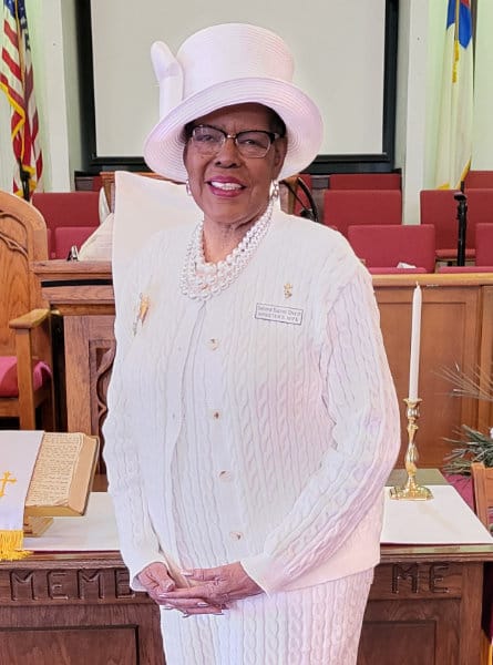 woman in a hat and white dress