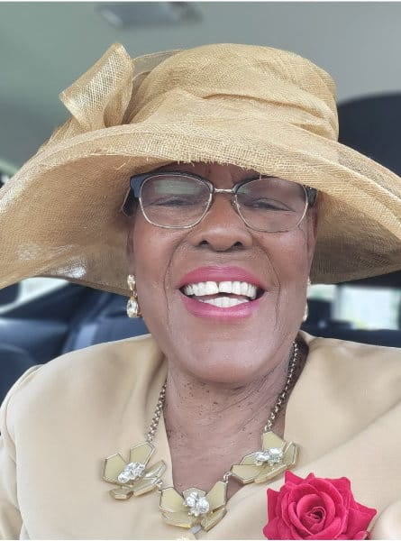 woman in a hat and tan outfit
