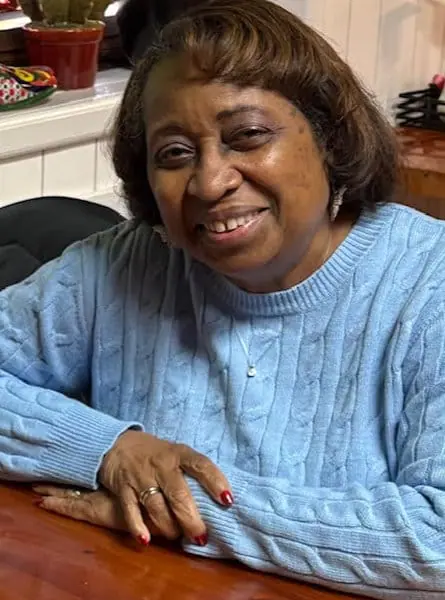 woman smiling in a blue sweater