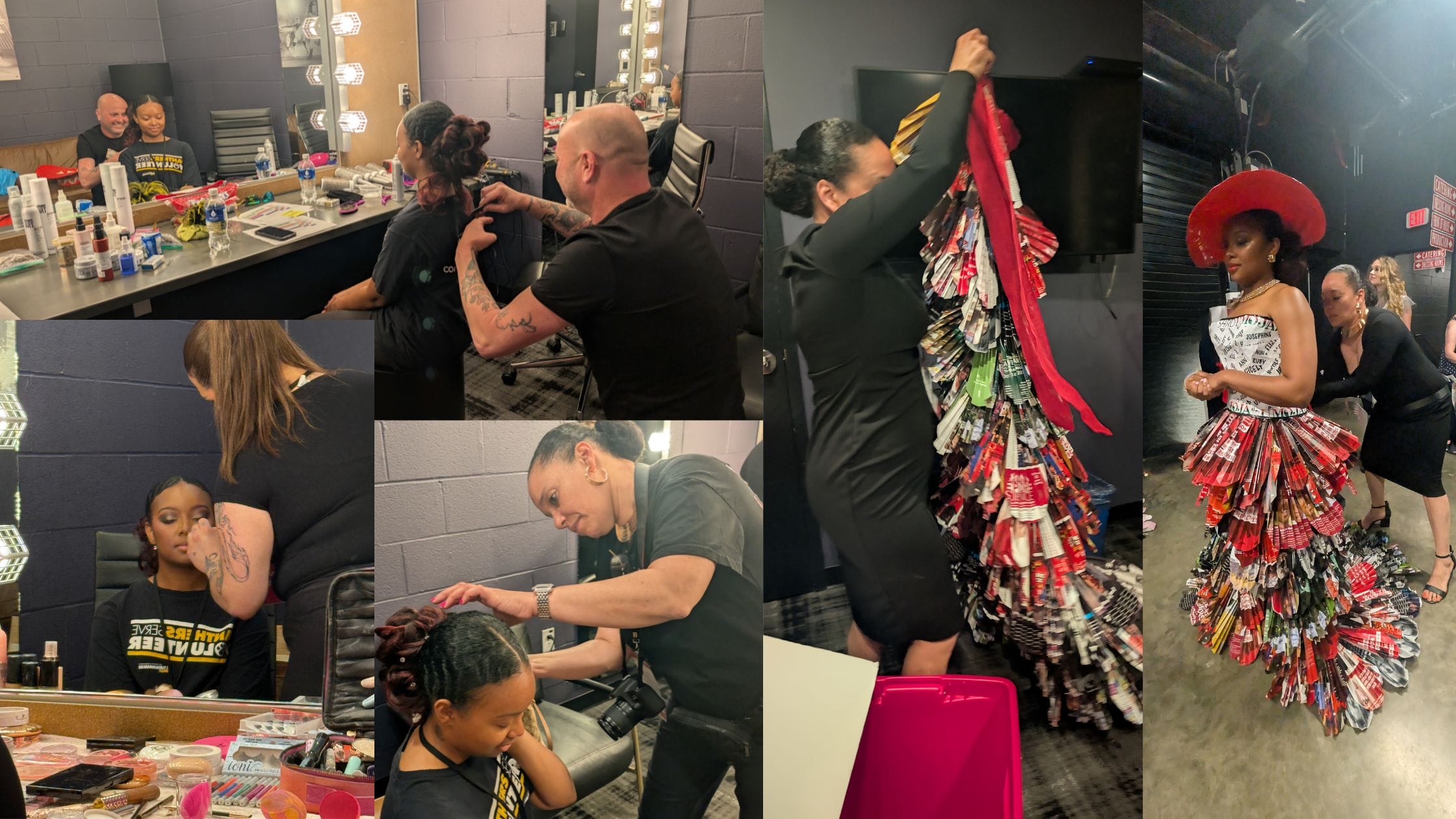 A woman in a colorful, layered dress made of magazine pages is assisted by stylists in a backstage dressing room.