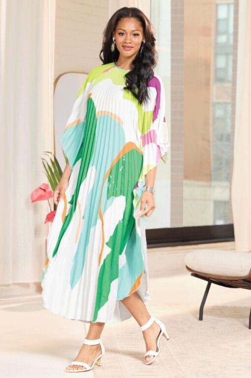 Black model wearing white dress with color blocks of line green, dark green, and cyan-ocean blue