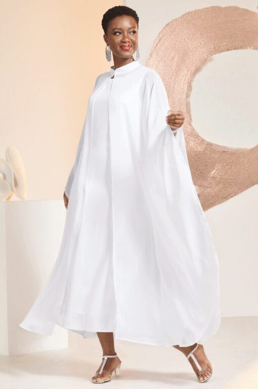 black model in white dress and flowy cape