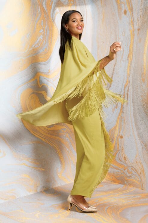 Model showcasing a stylish fringe outfit set with coordinating pieces and eye-catching fringe accents.