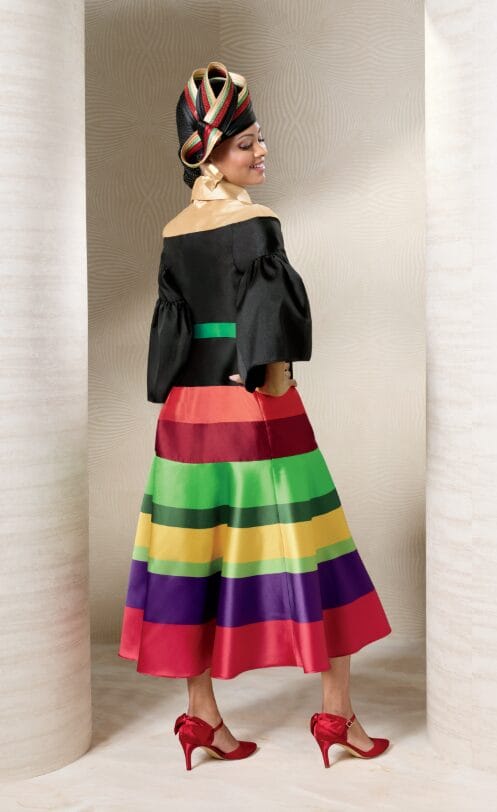 Model wearing the Multi-Striped Fit-and-Flare Dress, showcasing the rich multicolor stripes and decorative gold-tone buttons.