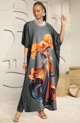 Woman in a dark grey kaftan with a vibrant orange and blue abstract floral print.