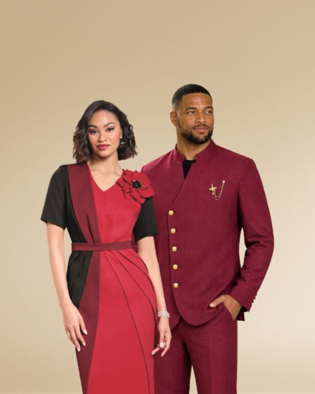 Couple in matching burgundy suits, woman in dress with black sleeves and red accents.