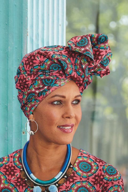 African-American woman wearing pink and blue multi-print headwrap
