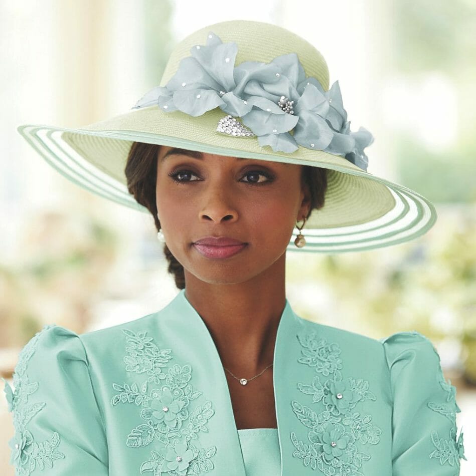 black woman wearing straw hat with elegant blue florals and clear beads