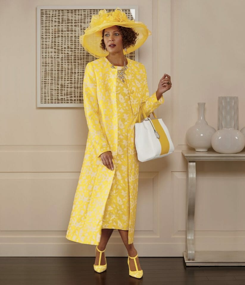 African-American woman wearing yellow and white flower print dress and matching hat