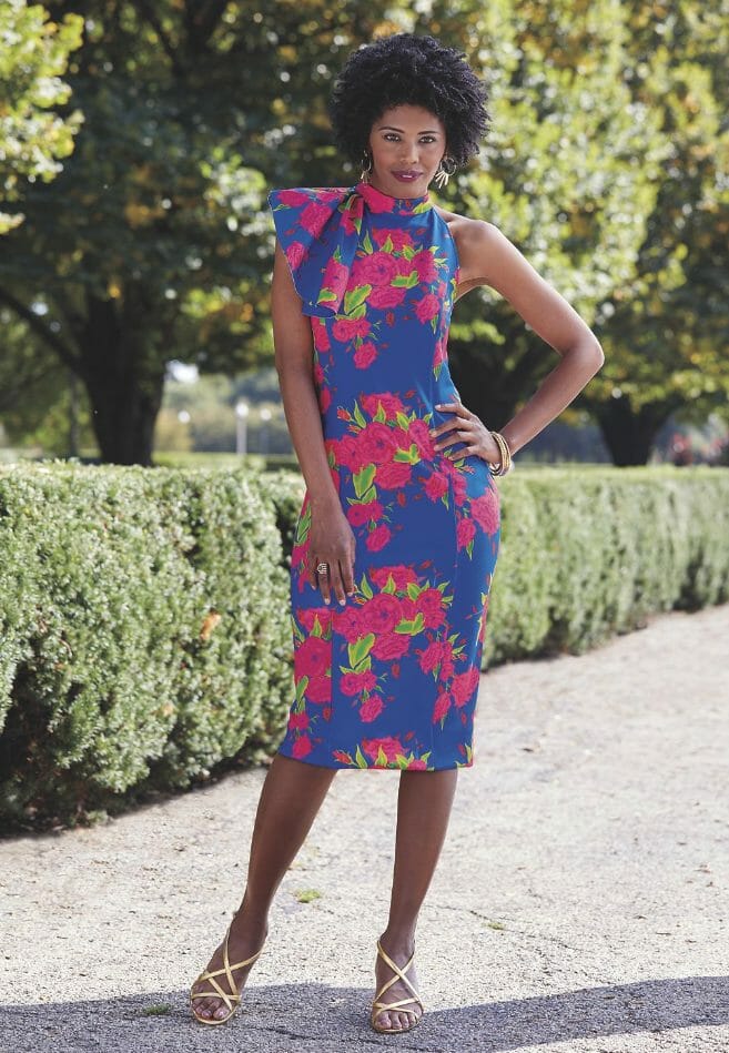 African-American woman in blue sleeveless dress with pink flower print