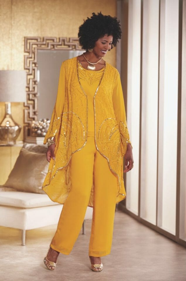 African-American woman in yelllow pantsuit with matching long jacket