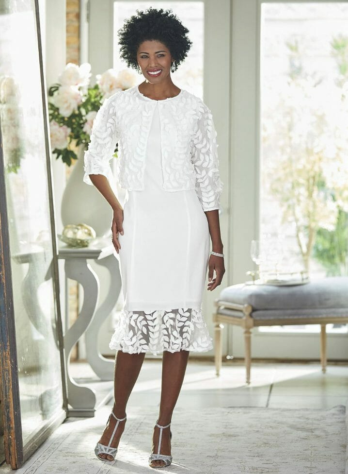 black woman wearing white mesh jacket dress with fabric leaves embellishments