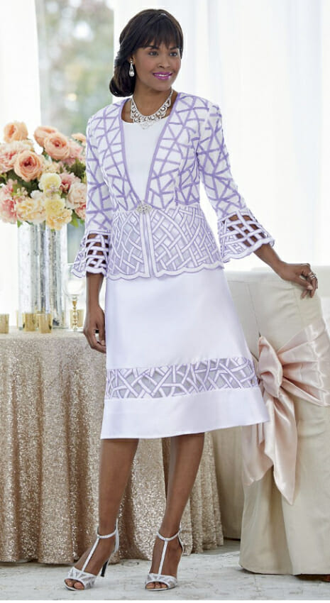 An African-American woman in a white and lavender crochet jacket dress.