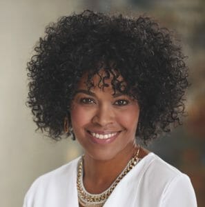 black woman wearing short curly black wig