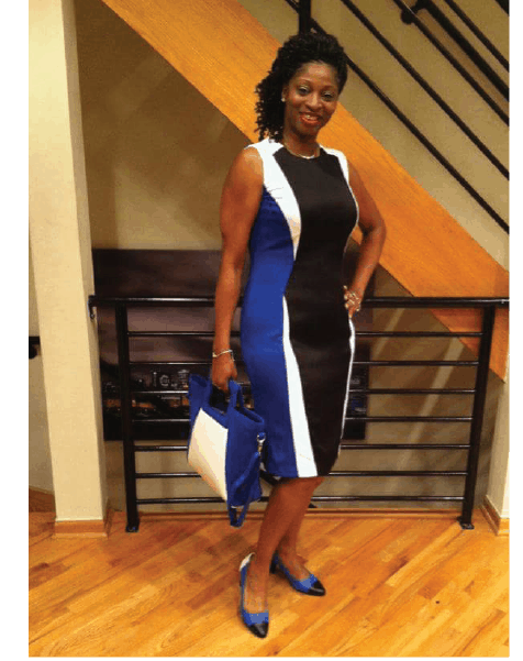 Ashro lookbook customer Barbara, a smiling black woman in a navy, white and black dress, with hair to the side.