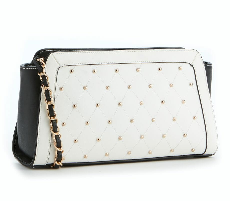 A white and black clutch bag with gold studs detail on the front.
