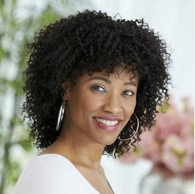 black woman wearing black kinky, curly wig