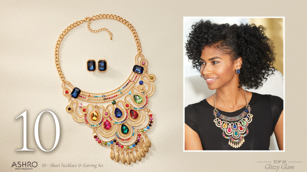 A black woman wearing a multi-color jewels and gold-tone bib necklace and blue jewel stud earrings.