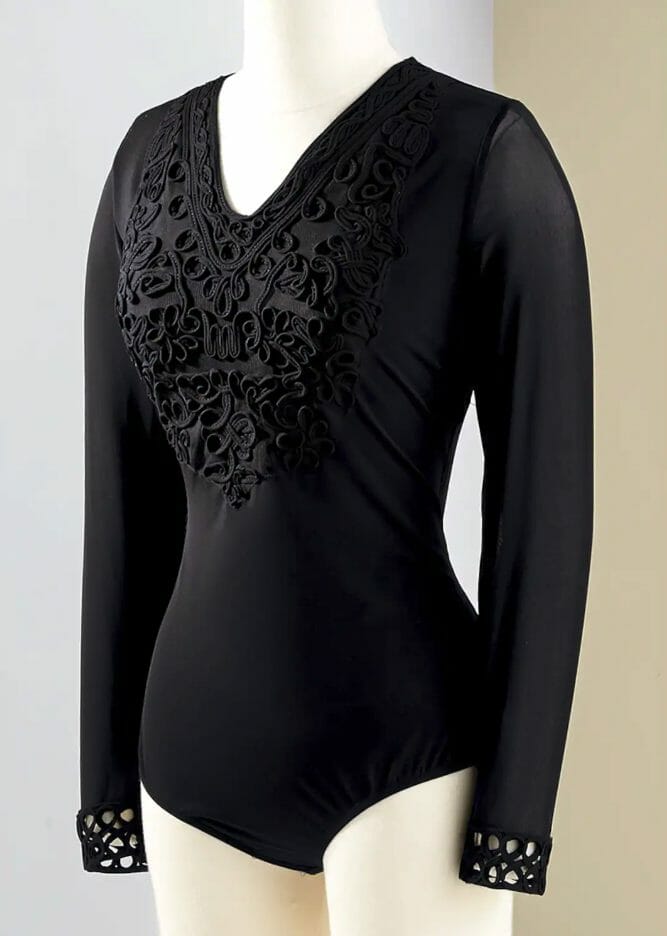 A black body suit with black applique detail on a dress mannequin.