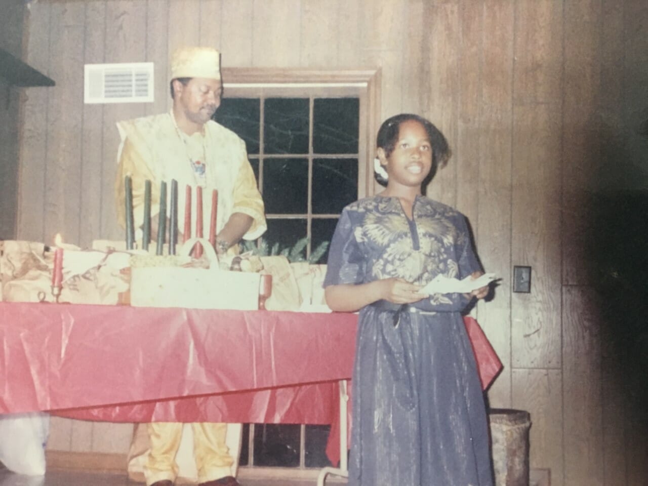 An African-American girl and a man celebrating Kwanzaa.