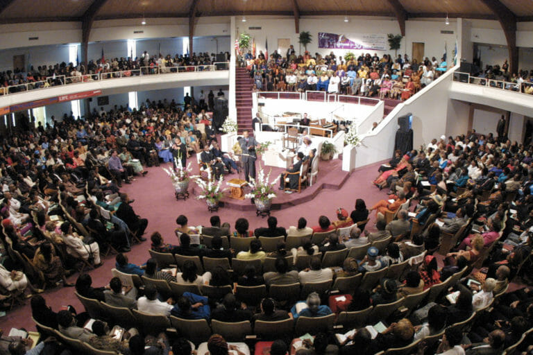 African-Americans in gathered in a large church.
