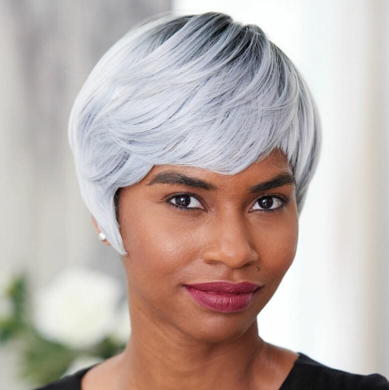 An African-American woman in a black top and short, smooth, silver wig with bangs by Vivica Fox.