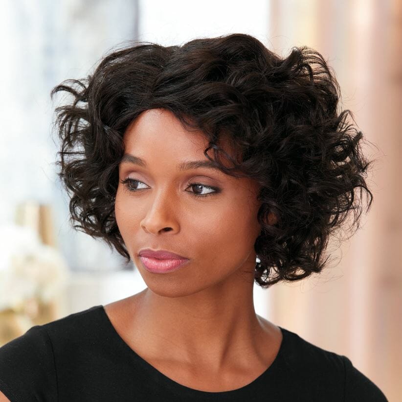 An African-American woman wearing a short, off-black wavy Vivica Fox wig and a black top with rounded neckline.
