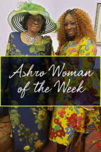Ashro Woman of the Week, Alysha, a black woman with curly auburn hair, in a yellow floral dress with full skirt.