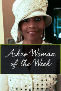 Ashro Woman of the Week, Dr. Angela, a black woman in a cream hat with gold polka dots and matching suit.